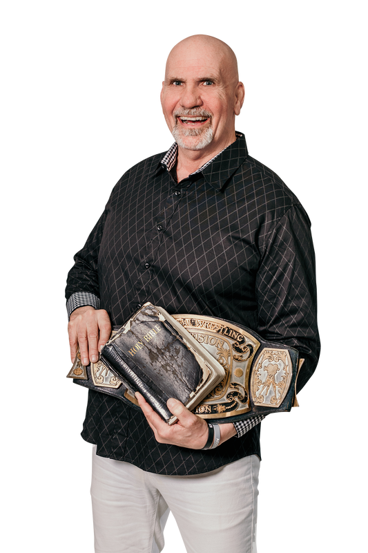 Nikita Koloff holding his championship belts and a well-worn Bible